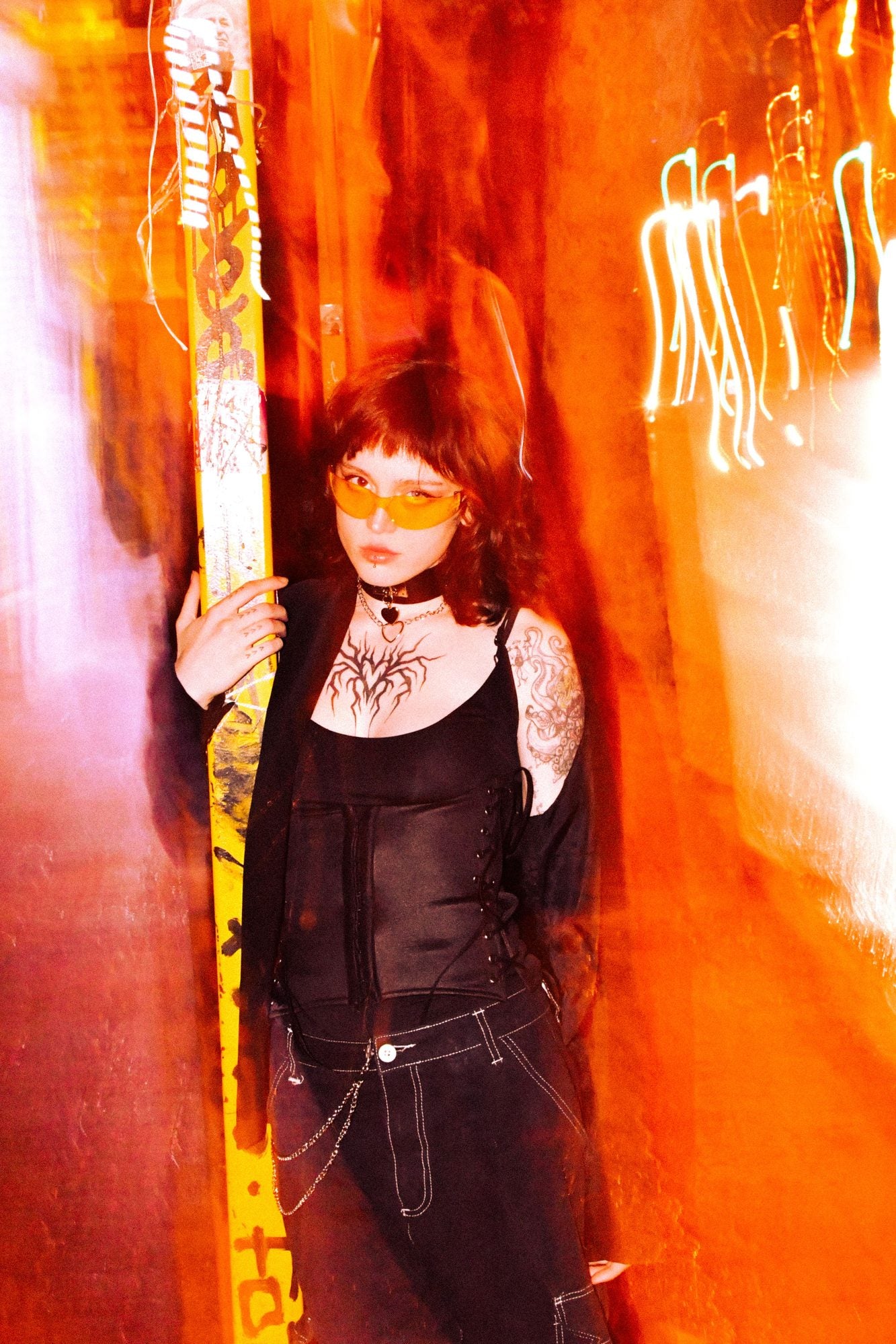AXYRON — tinted lenses in an orange-lit alley