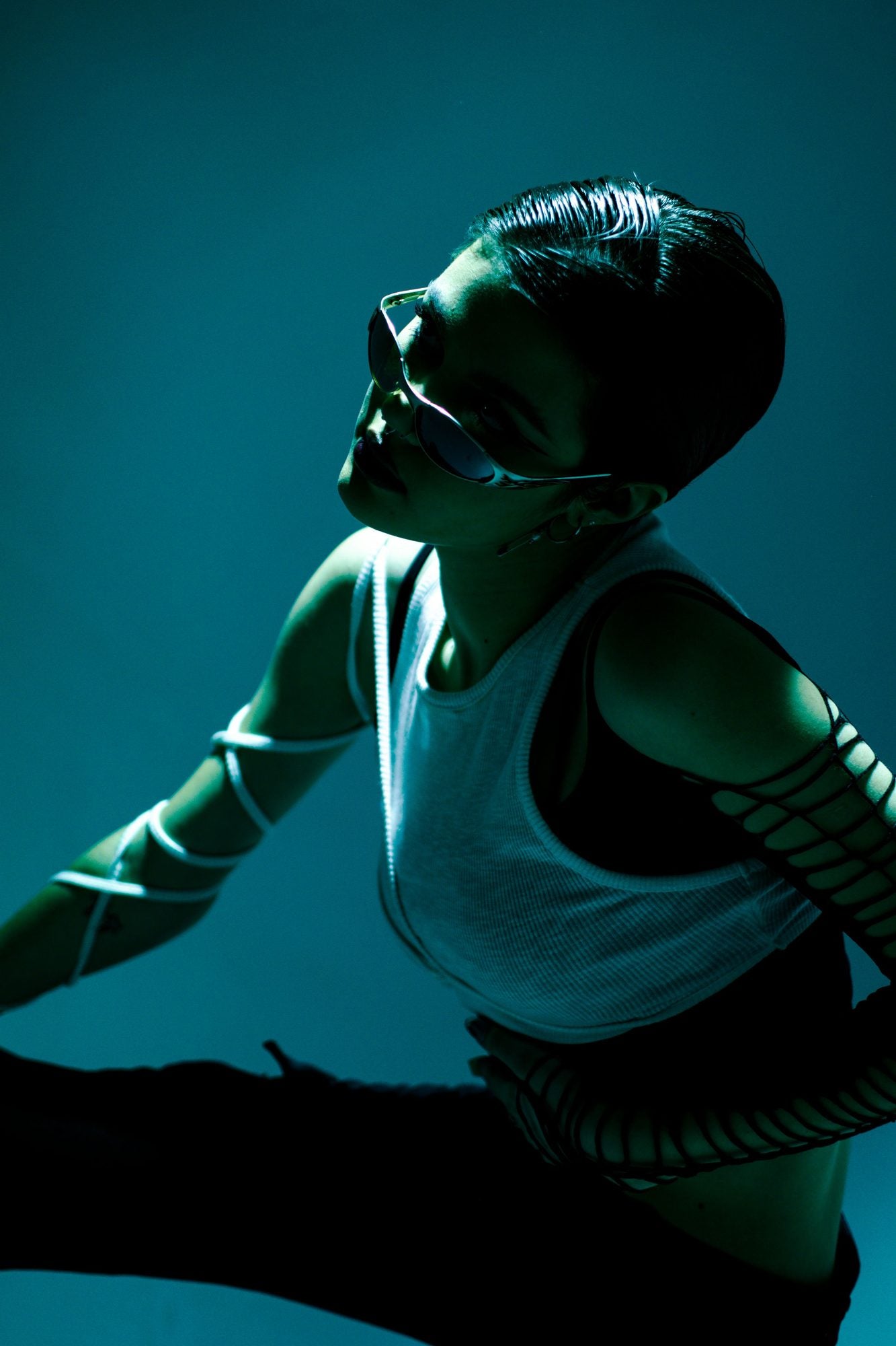 AXYRON campaign — wraparound sunglasses in teal studio light