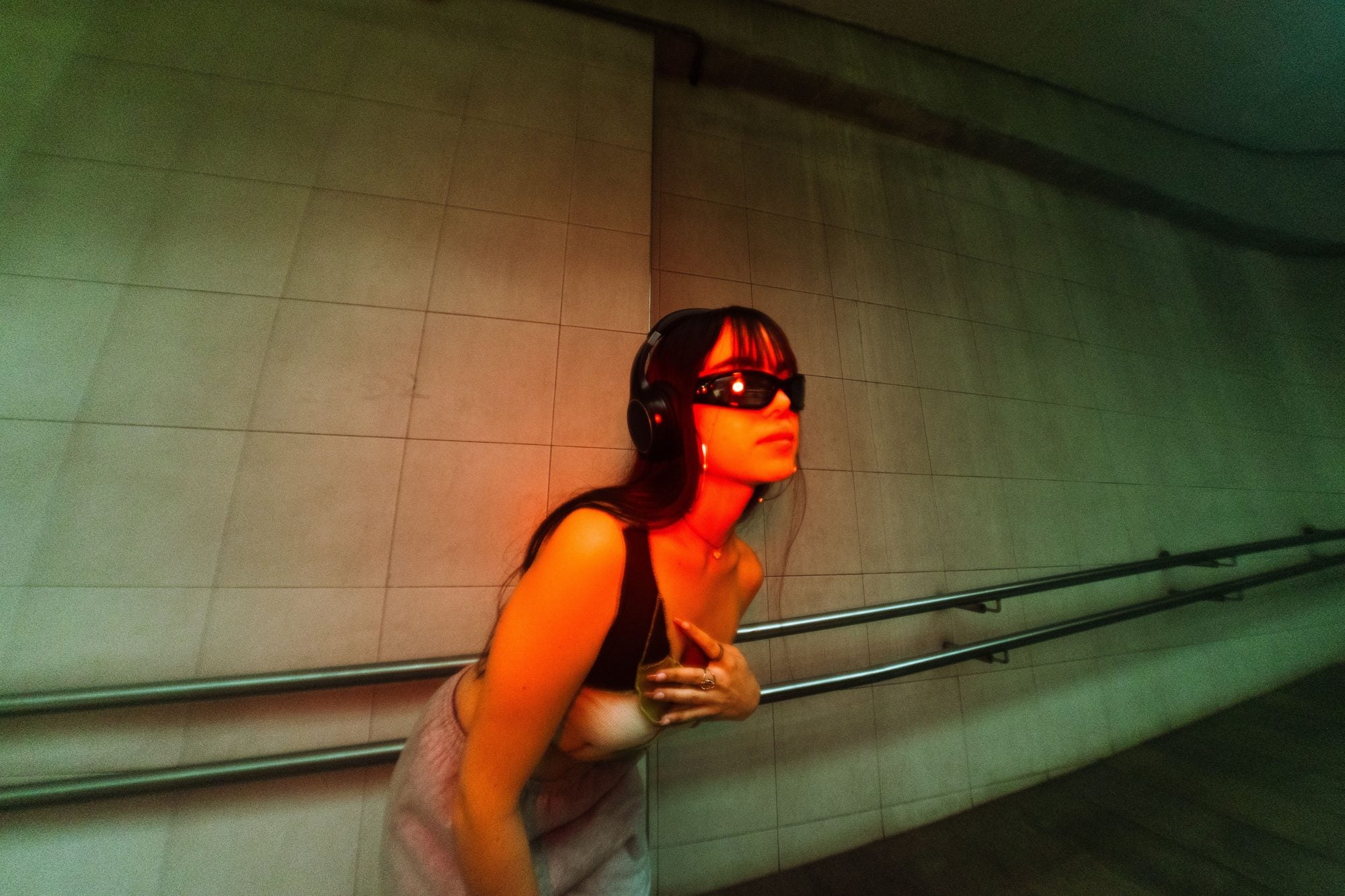 AXYRON campaign — sunglasses under red light in an underground tunnel